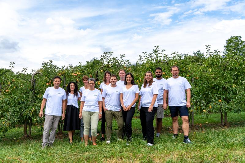 Our team in front of apple trees